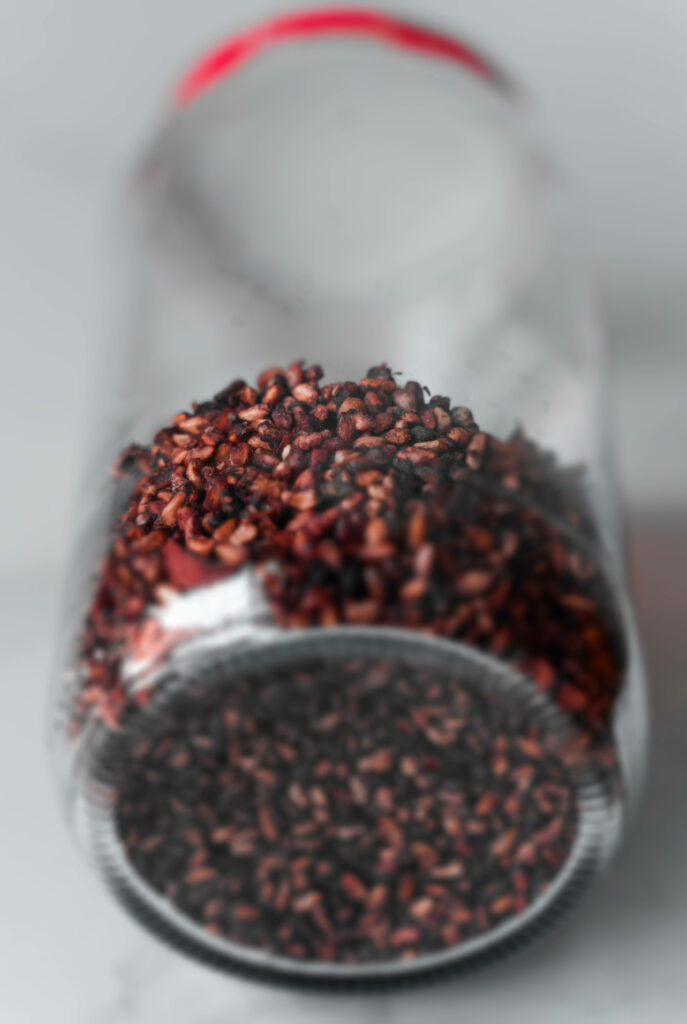Scattered Roasted Rice Grains in a Jar - Earthy Wallpaper Background