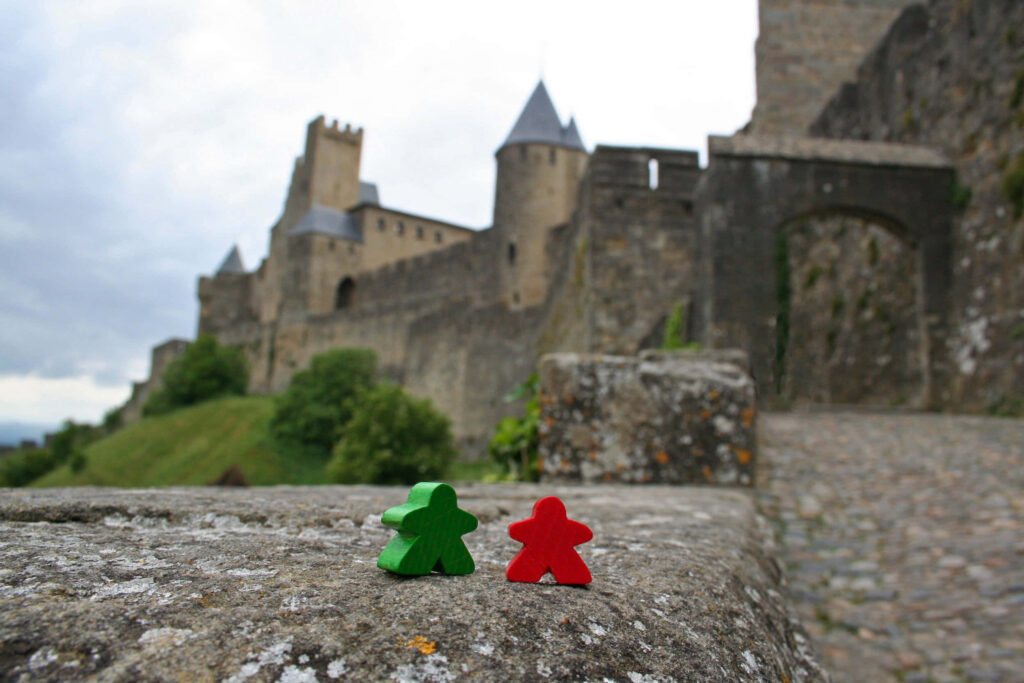 Scenic Carcassonne Castle: Meeple Figures & Stunning Wallpaper Background