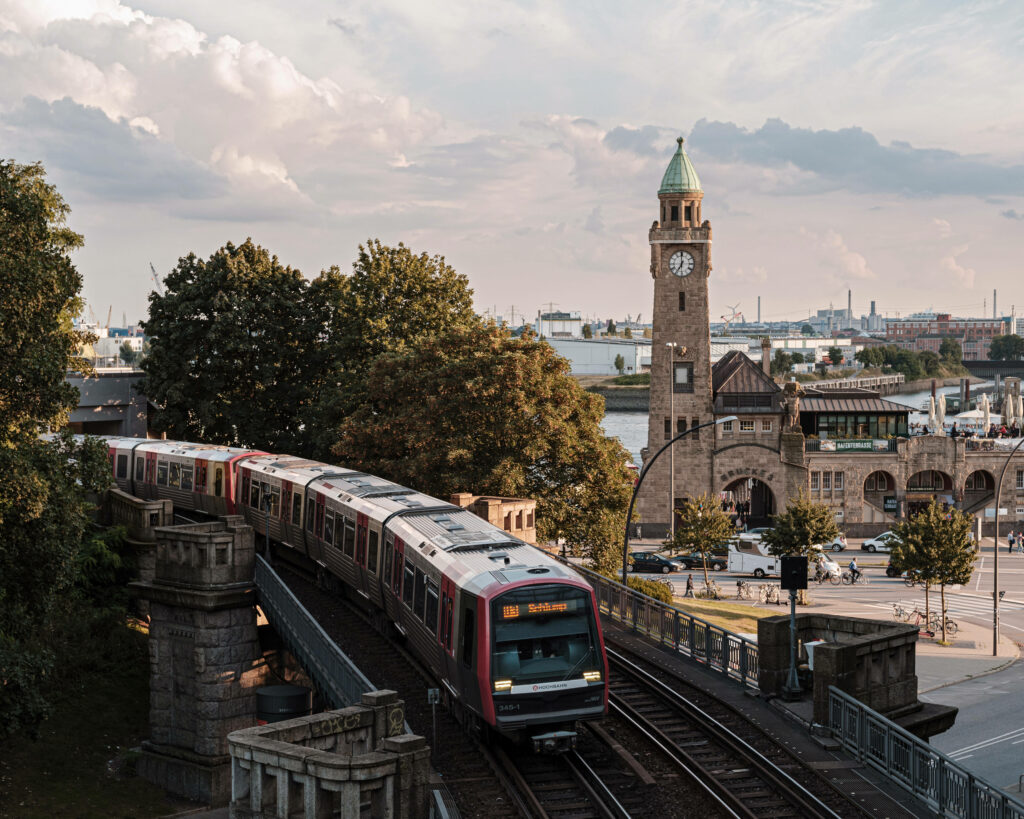 Scenic Germany Railroad: Train, Clock Tower & Urban Landscape Wallpaper