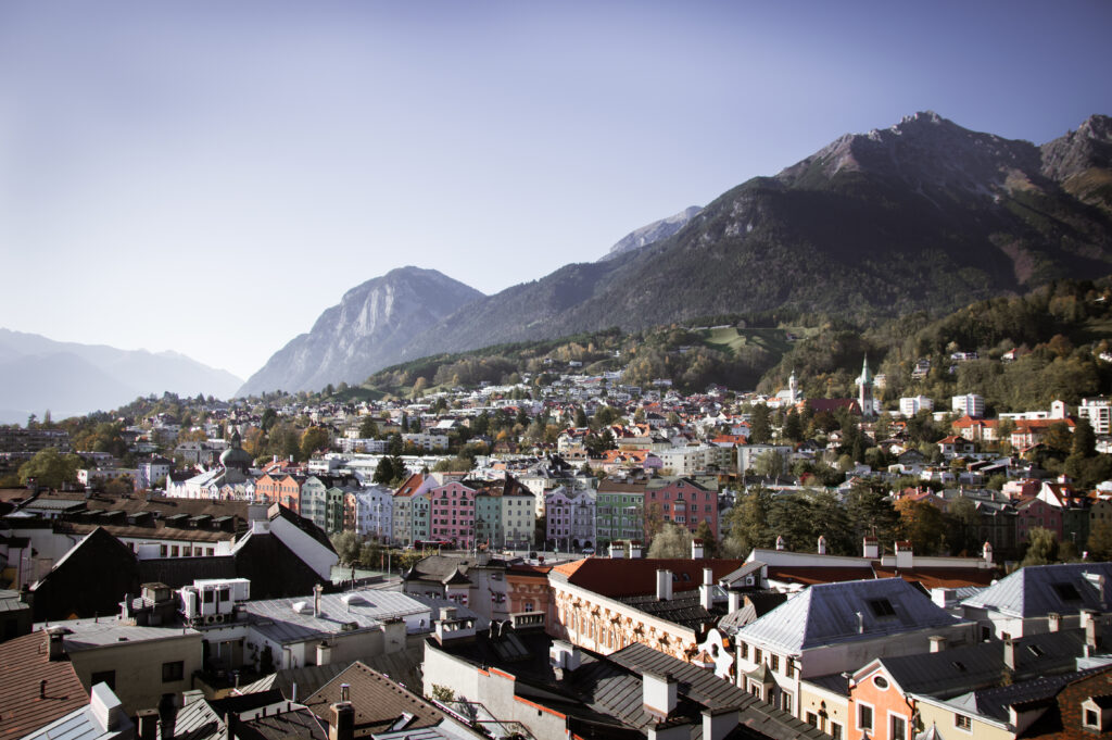 Scenic Mountain Town Wallpaper: Serene Village Amidst Lush Greenery