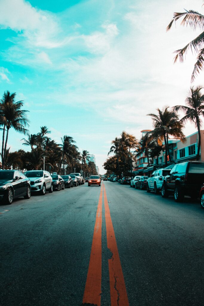 Tropical Road Wallpaper: Palm Trees, Cars & Blue Sky Background