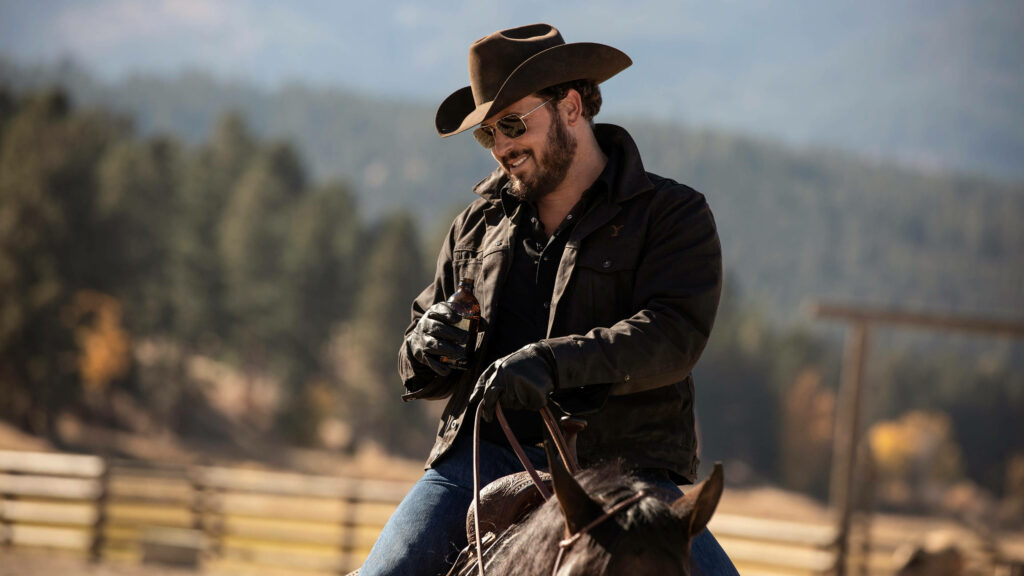 Rip Wheeler Wallpaper: Rugged Charm on Horseback in Scenic Landscape