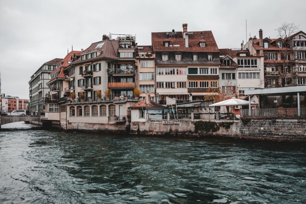 Scenic Riverside Wallpaper of Thun, Switzerland: Serene Townscape