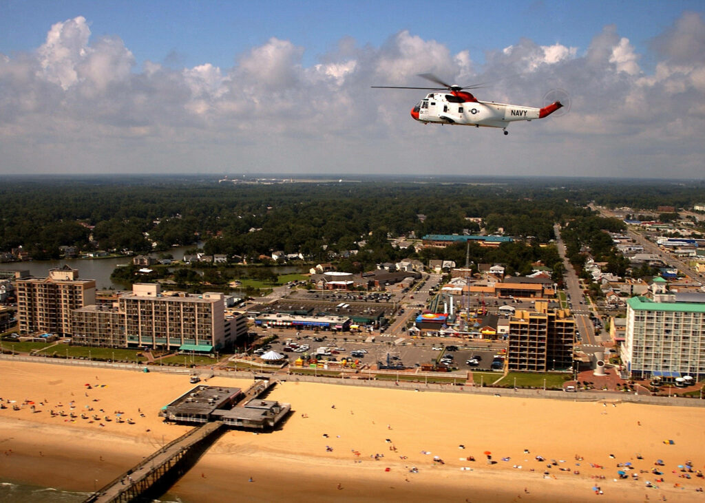 Stunning Aerial View of Virginia Beach with Helicopter Over Shoreline Wallpaper