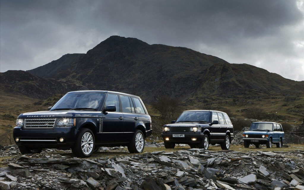 Scenic Wallpaper: 3 Colorful Land Rovers in Rugged Mountain Landscape