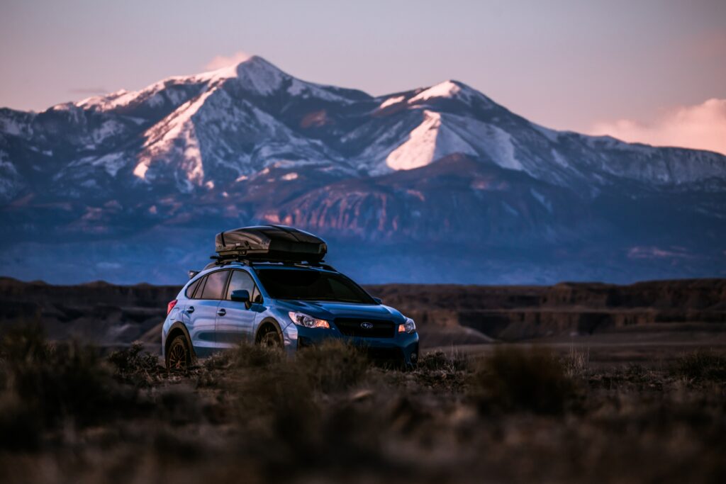Blue Subaru Outback Wallpaper: Adventure in Snow-Capped Mountains