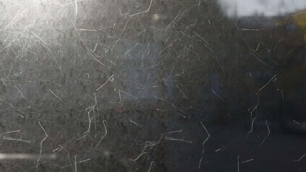 Textured Wallpaper: Scratched Glass Surface with Urban Reflections