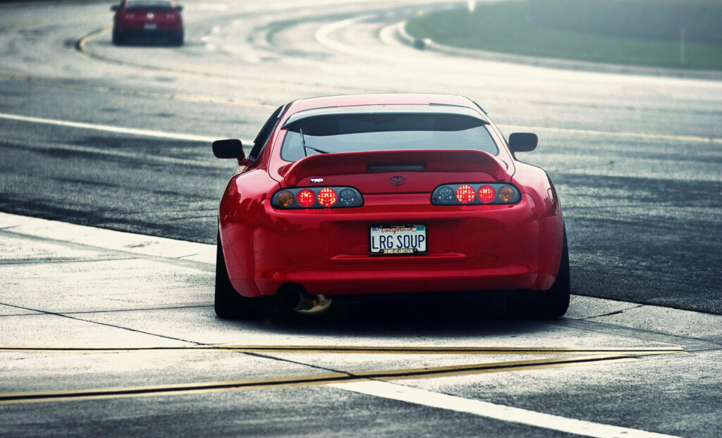 Roaring Red Rocket: 4K JDM Supra Speeding Down an Asphalt Highway Wallpaper
