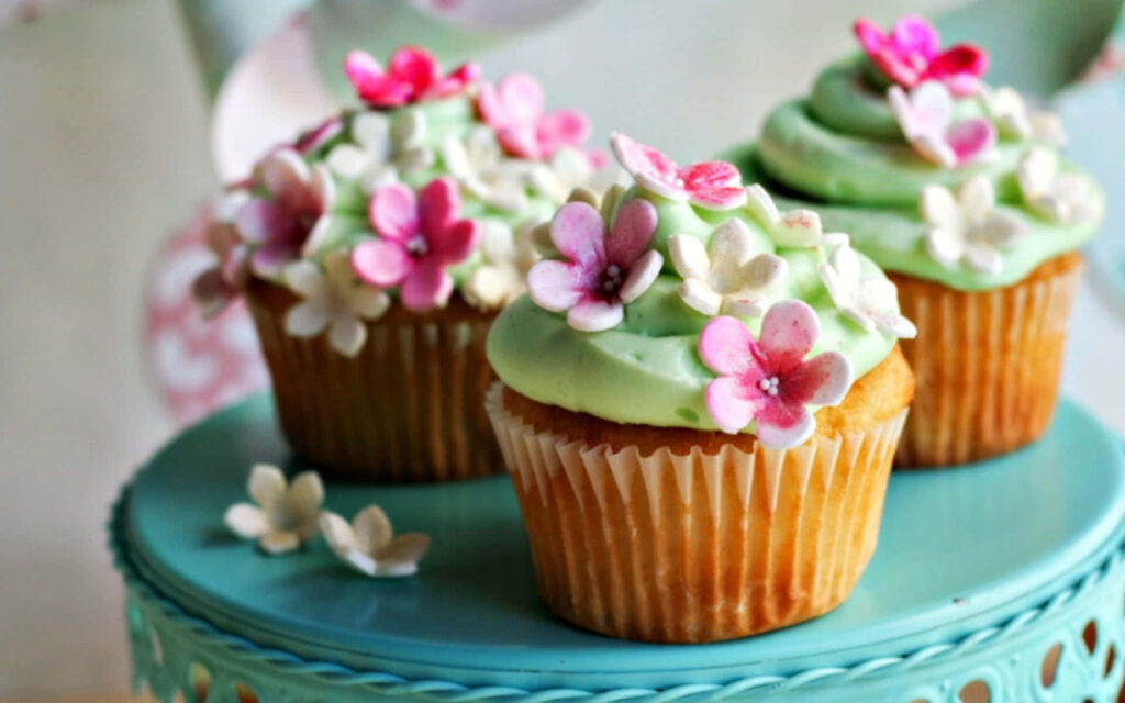 Spring Delights: Tempting Berry Tarts Brimming with Fresh Blooms on a Rustic White Wood Canvas Wallpaper