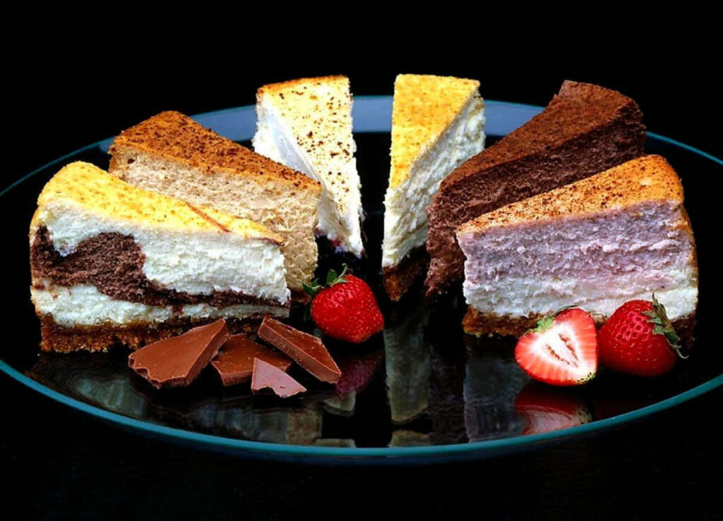 Decadent Cake Medley: Tempting Flavors on Display Amidst Chocolate and Strawberries Wallpaper