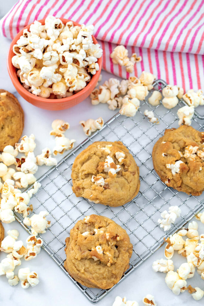 The Perfect Snack-Filled BBQ - Piles of Popcorn and Cookies Unveiled on a Bright Tabletop Wallpaper