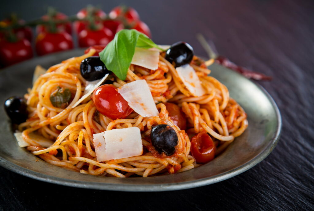 Savory Italian Delight: HD Wallpaper showcasing exquisite Spaghetti pasta steaming with flavors
