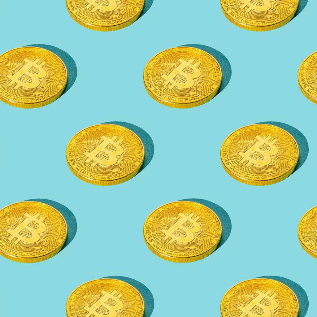 Seamless pattern of shiny gold Bitcoin coins on vibrant blue background cryptocurrency wallpaper