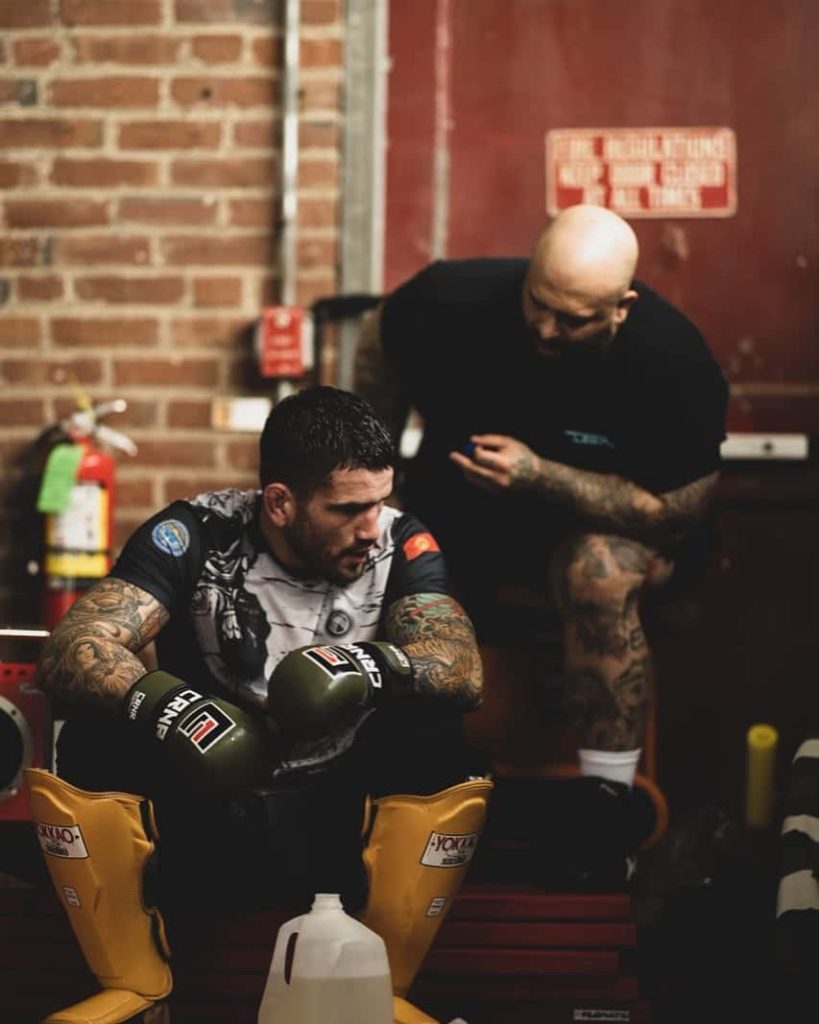 Sean Brady UFC training with coach in industrial gym intense focus MMA fitness wallpaper background