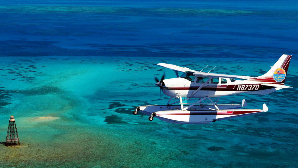 Aircraft Gracefully Descending onto Pristine Turquoise Ocean: Spectacular HD Seaplane Background Wallpaper
