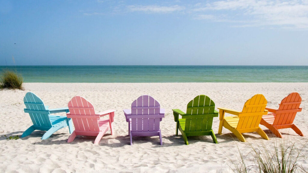Beach Bliss: Vibrant Wooden Chairs Set the Stage for a Perfect Summer Getaway Wallpaper