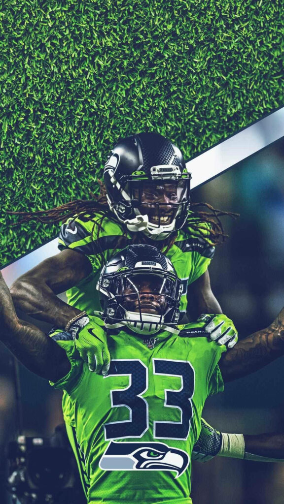 DK Metcalf and Jamal Adams Seattle Seahawks neon green uniforms celebrating on vibrant turf wallpaper