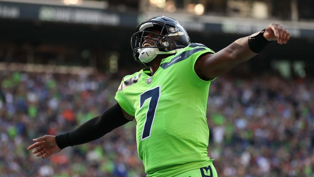 Seattle Seahawks quarterback Geno Smith in Action Green jersey celebrates on game day wallpaper background