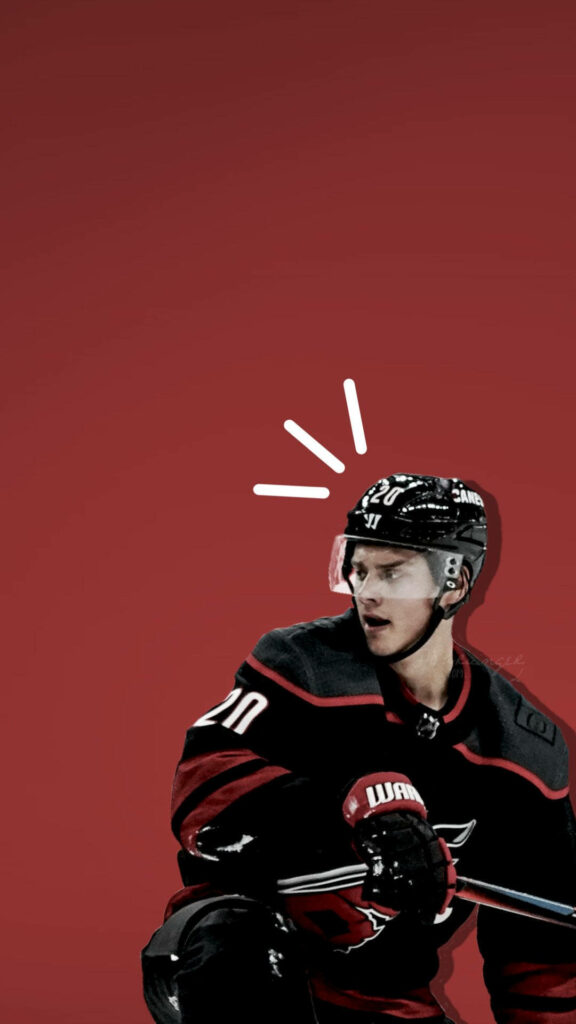 Sebastian Aho Carolina Hurricanes in action wearing black and red uniform on bold red background Wallpaper