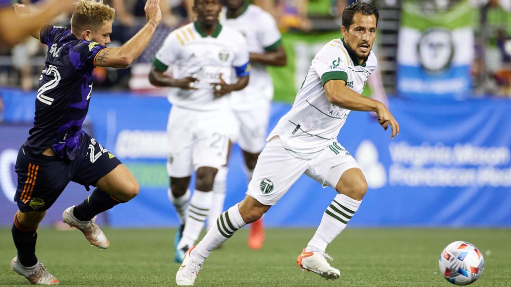 Sebastian Blanco skillfully dribbling past Houston Dynamo defender in intense MLS match wallpaper