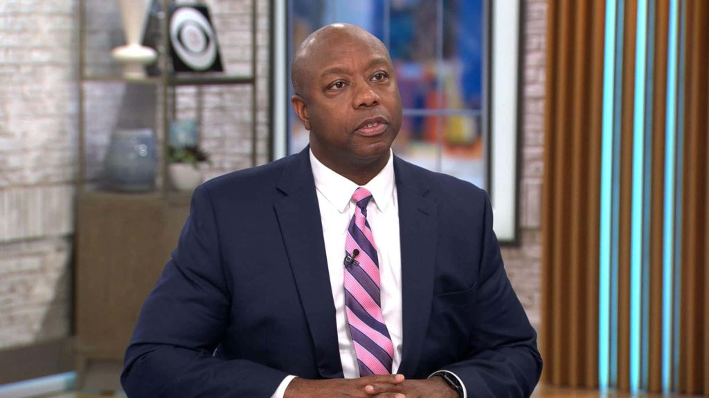 U.S. Senator Tim Scott in navy suit CBS Mornings bright news studio wallpaper background