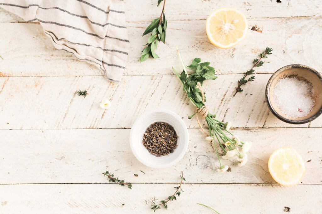 Aromatic Infusion: Colorful Spices and Fragrant Herbs Embrace Zesty Citrus Slices on a Rustic Wooden Canvas Wallpaper