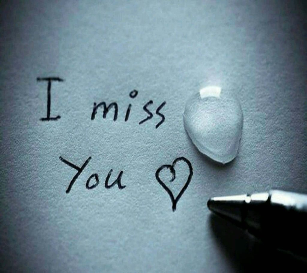 Macro photo of I miss you handwritten with heart and water droplet on textured paper wallpaper