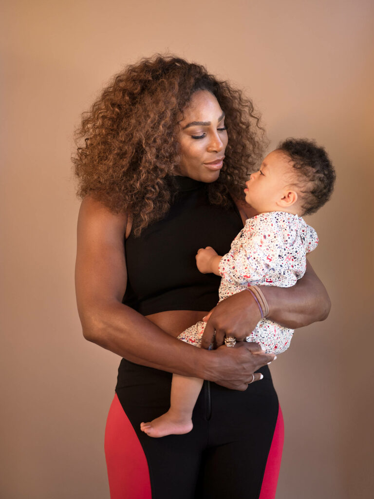 Serena Williams tenderly holding her daughter showcasing strong mother daughter bond wallpaper