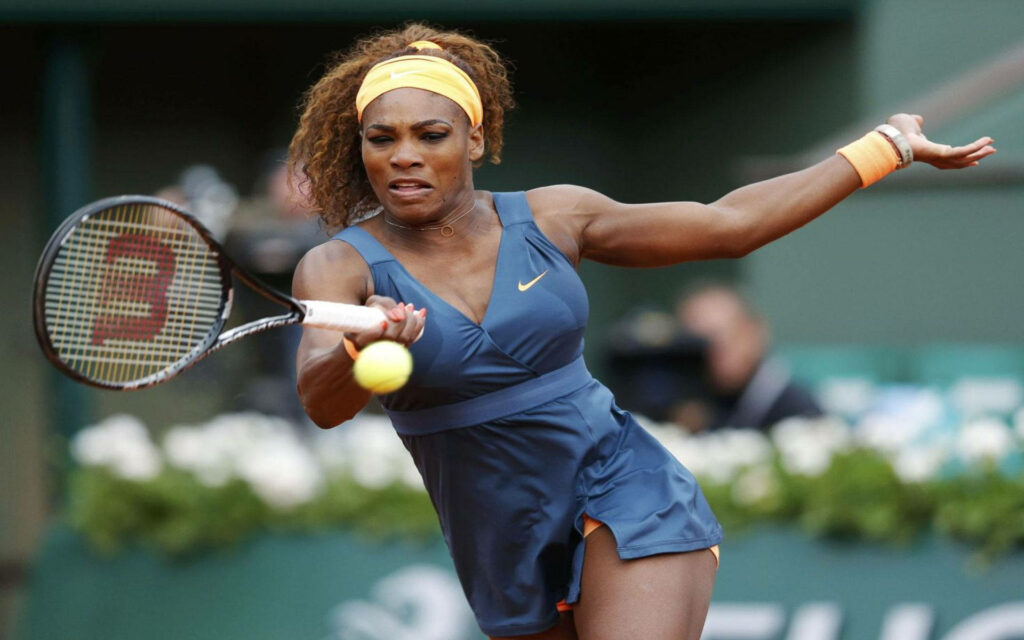 Serena Williams focused tennis player returning shot powerful energy on court wallpaper background