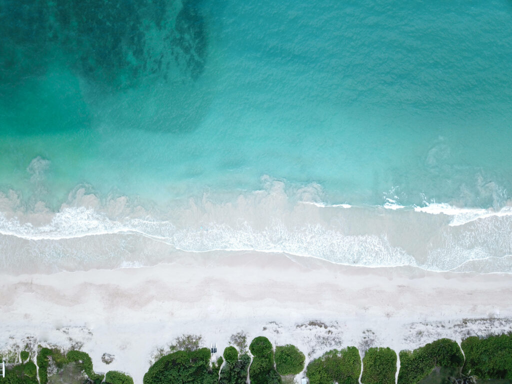 Tranquil Beach Aerial Wallpaper: Serene Ocean Scene for Your Desktop