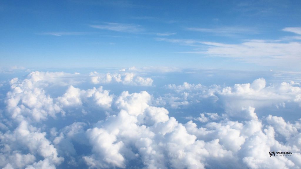 Aerial view of fluffy white cumulus clouds under bright blue sky calming wallpaper background