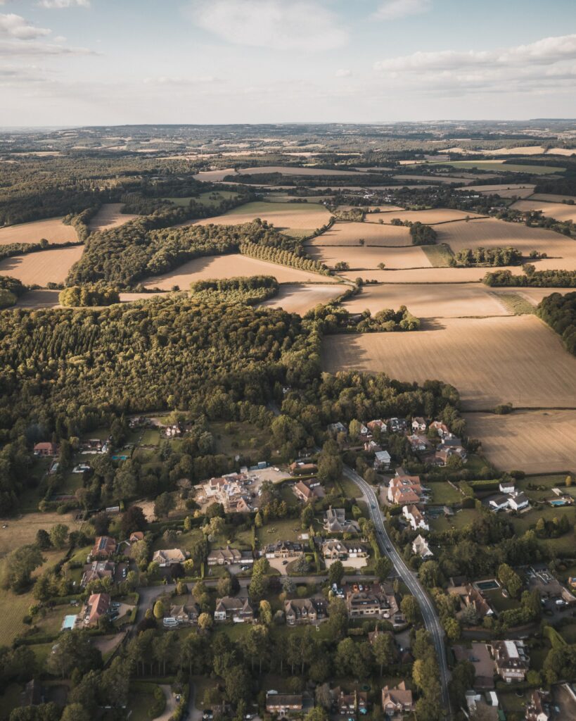 Serene Aerial Countryside Wallpaper: Cozy Homes & Lush Nature