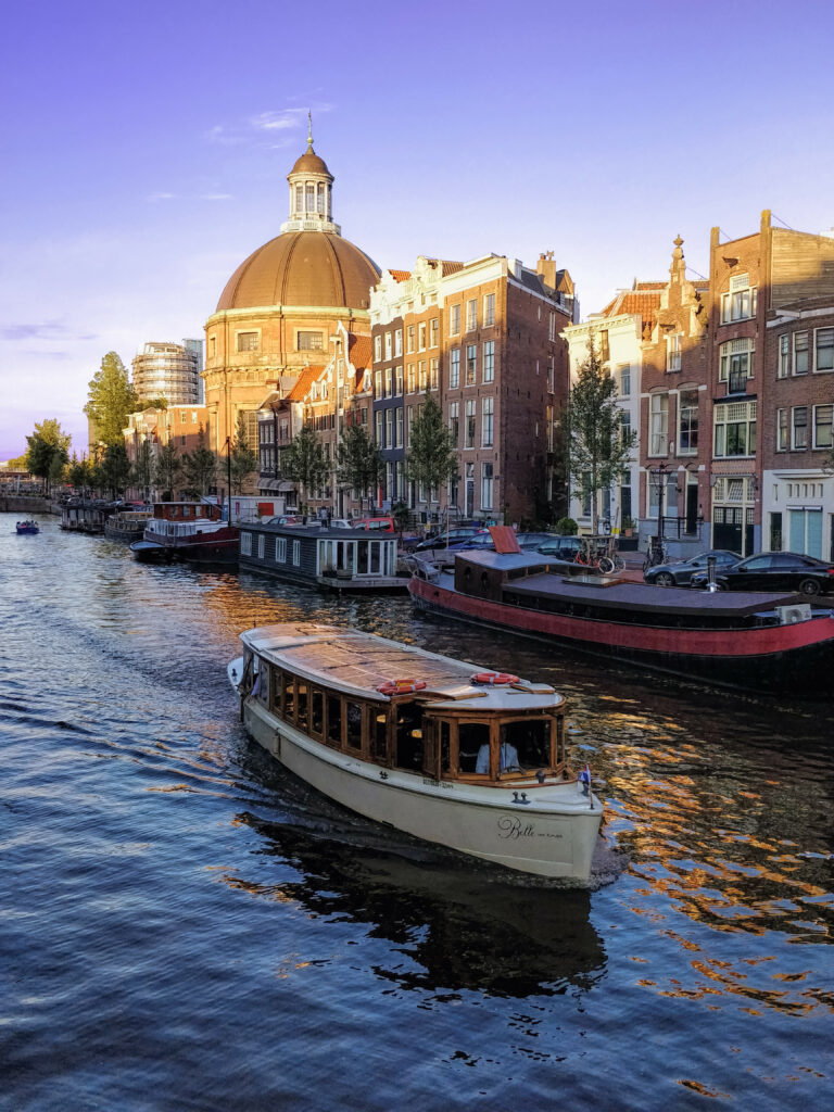Serene Amsterdam Canals: Historic Buildings & Classic Boat Wallpaper Background