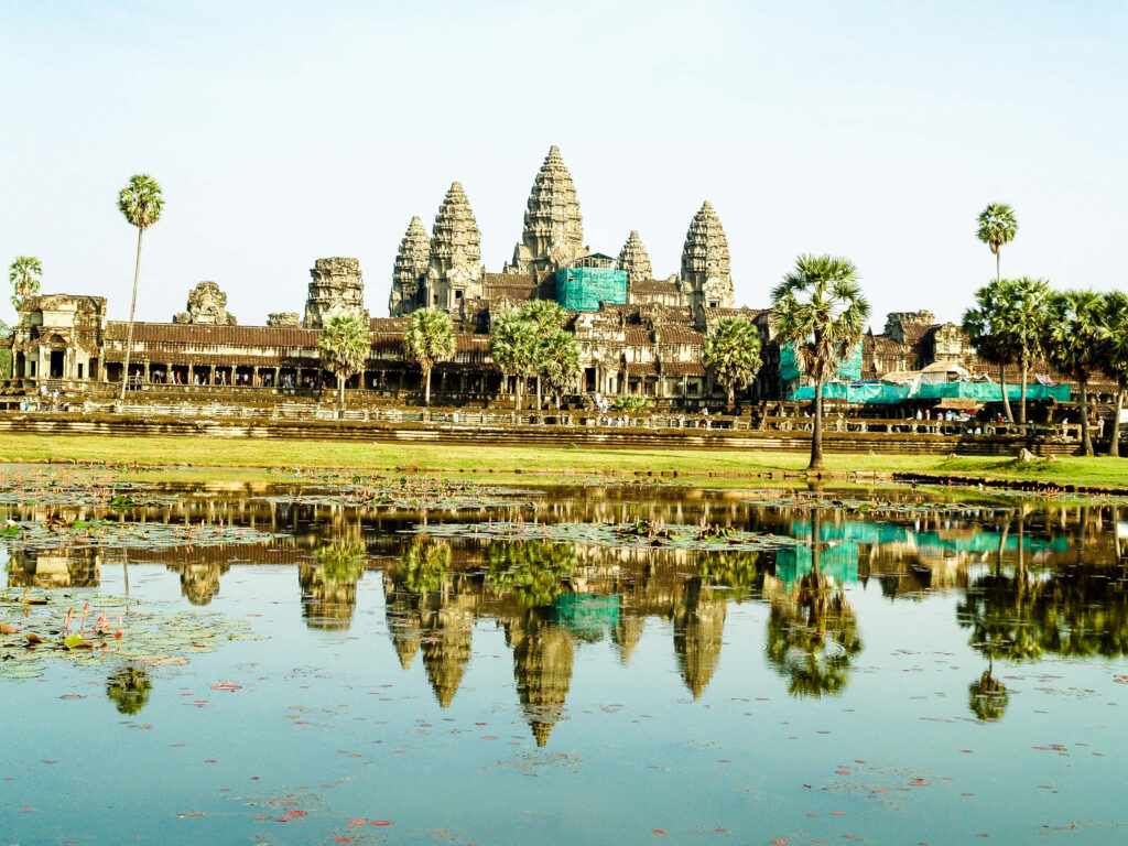 Angkor Thom reflection surrounded by lush greenery and calm water serene green wallpaper background
