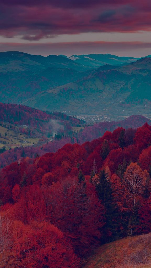 Serene iPhone wallpaper with crimson autumn forest and twilight mountain landscape background