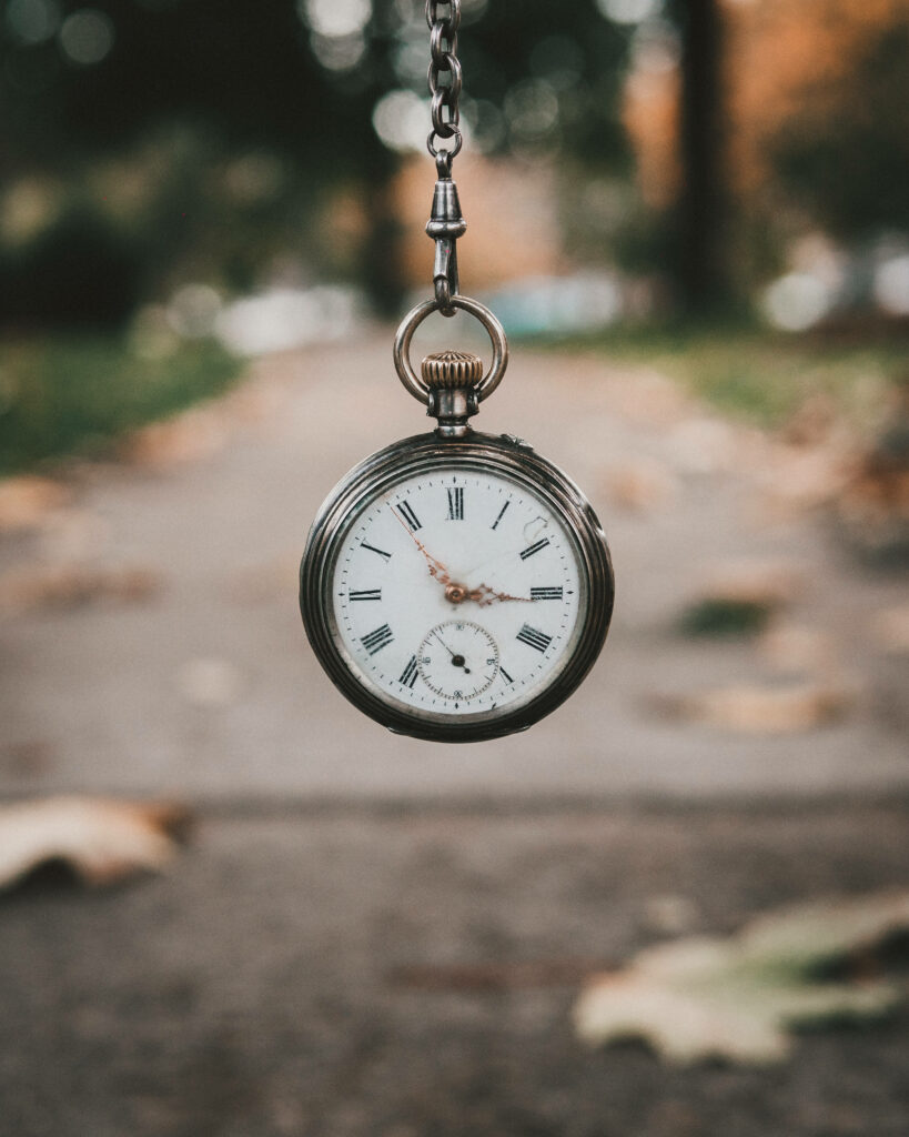 Serene Autumn Scene: Antique Pocket Watch & Blurred Pathway Wallpaper