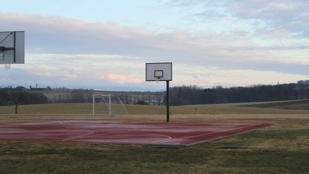 Peaceful Basketball Court Wallpaper in a Serene University Park