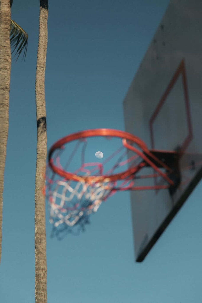Serene Basketball Hoop Wallpaper: Moonlit Sky & Palm Tree Background
