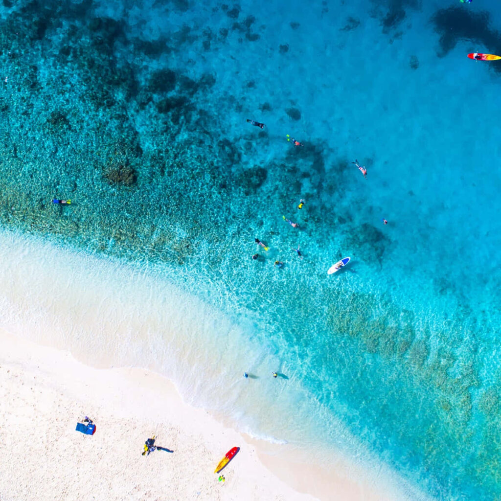 Tranquil Beach Paradise: Aerial View of Turquoise Waters & White Sand Wallpaper