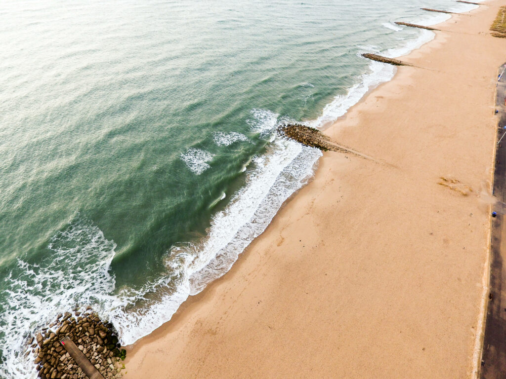 Tranquil Aerial View of Serene Beach and Gentle Waves Wallpaper