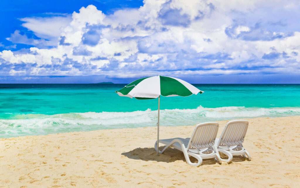 Tranquil Beach Oasis: Lounge Chairs Under Umbrella by Turquoise Waters Wallpaper