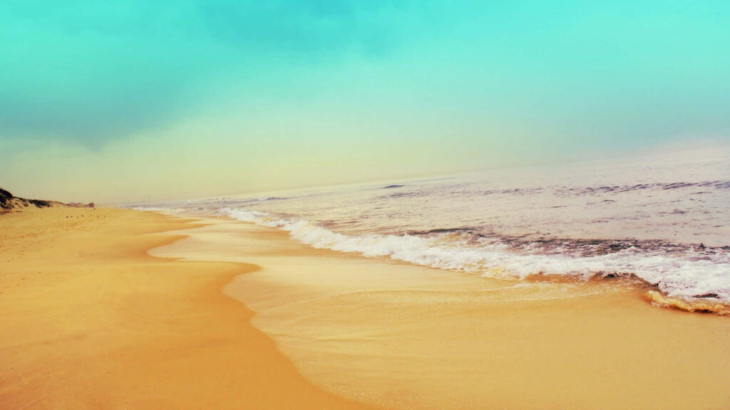 Serene Beach Wallpaper: Golden Sand, Gentle Waves & Tranquil Sky