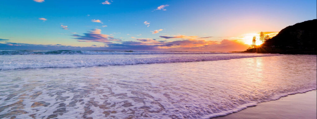 Serene Beach Sunset Dual Monitor Wallpaper for Relaxation