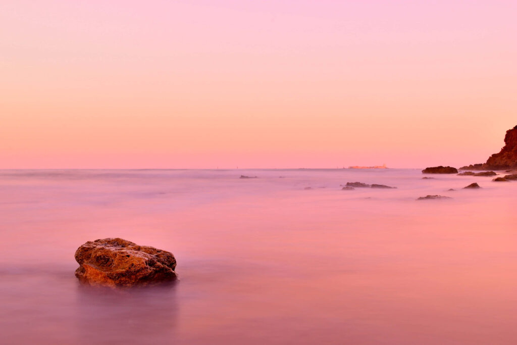 Serene Sunset Beach Wallpaper: Calming Pink & Orange Hues