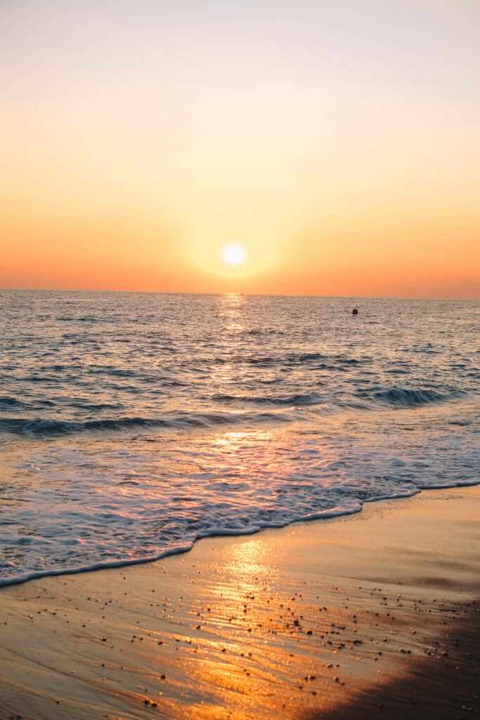 Serene Beach Sunset Wallpaper for a Tranquil Android Background