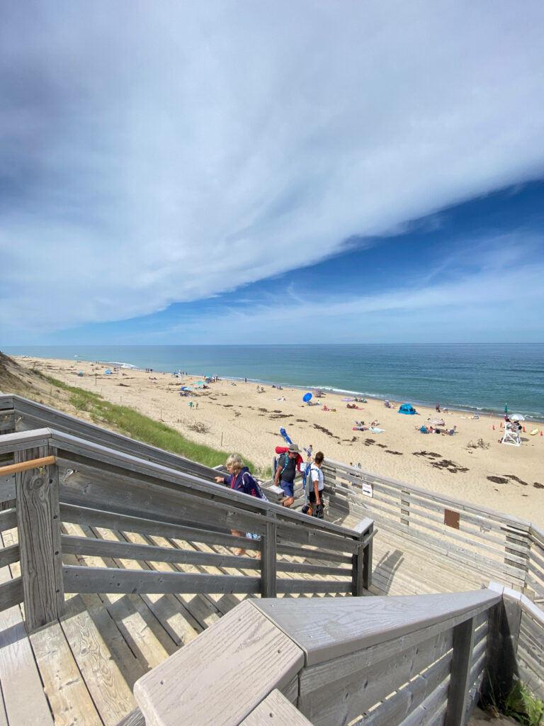 Serene Beach View from Wooden Deck: Relaxing Coastal Scene Wallpaper