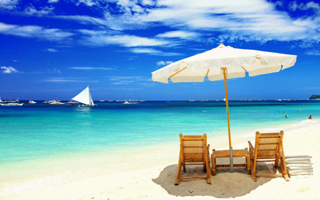 Serene Beach Scene Wallpaper: Chairs, Ocean, and Sailboat Bliss
