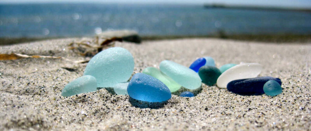 Serene Beach Wallpaper: Colorful Sea Glass on Sandy Shore