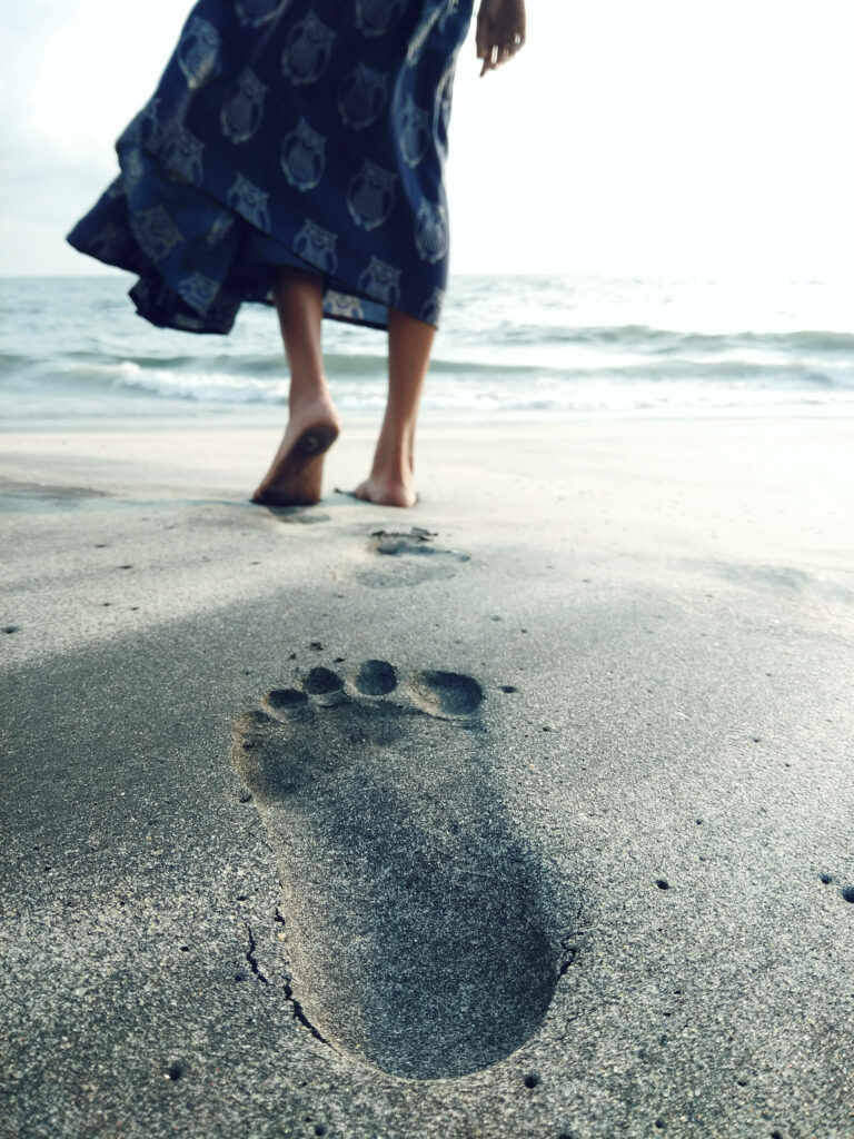 Serene Beach Wallpaper: Footprint in Sand for Calm Background