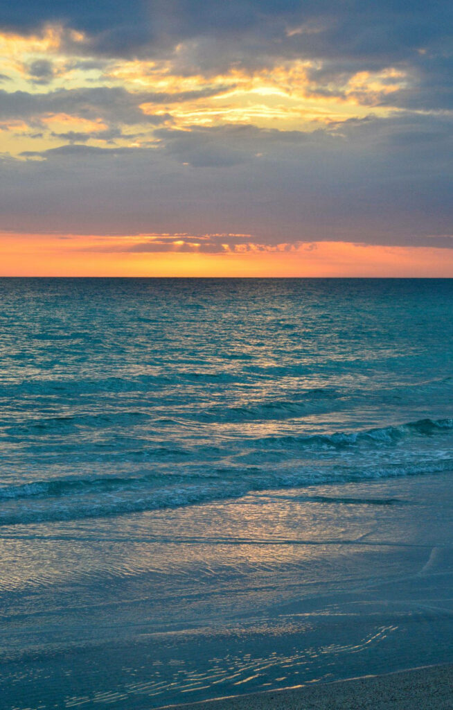 Serene Beach Wallpaper: Calm Waves & Colorful Sunrise Background